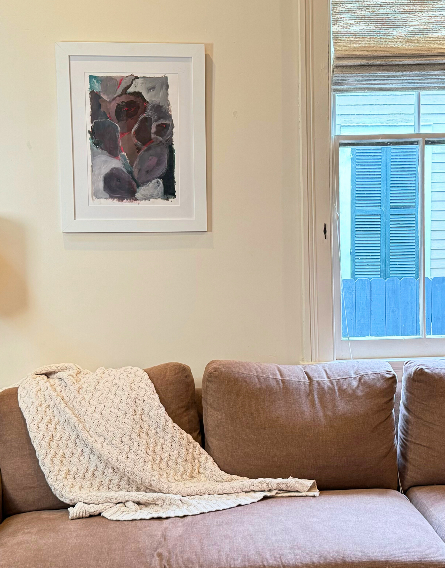 Ginger painting hanging on a wall above a couch